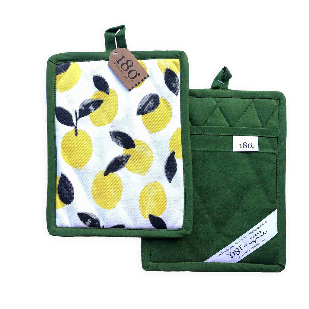 Two Hot Pads from Misha Zadeh Fantastical Fruit Collection. Lemons on a Green Backing and Blueberries on a Black Backing