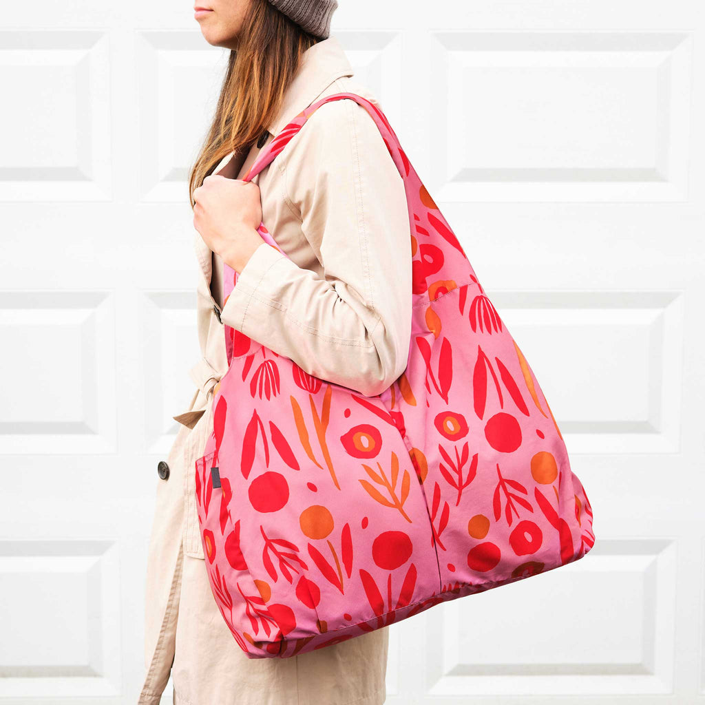 Misha Zadeh Poppy Tulip Power Handbag in pink with orange and tan tulips and poppies on it