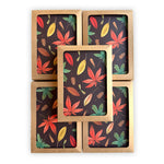 five stacked, boxed notecards featuring a hand painted autumn leaf pattern on a deep chocolate brown background.