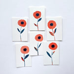 Handpainted and collaged original poppy gift enclosure cards by Misha Zadeh. Red poppies with blue and red stems