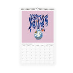 Misha Zadeh 2023 Calendar. September spread featuring a stylized orange branch in an asian blue and white vase. On a violet background.