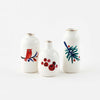 Misha Zadeh ceramic holiday bud vases in red bird with branch, big berries, and green fir branch