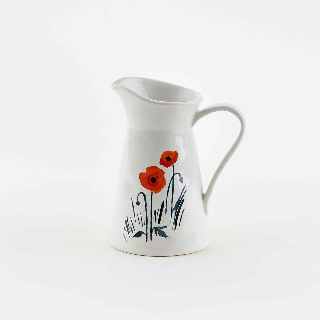 Red Poppies with Blue Stems and Leaves adorn a classically white farmhouse style ceramic creamer. By Misha Zadeh for 180 Degrees.