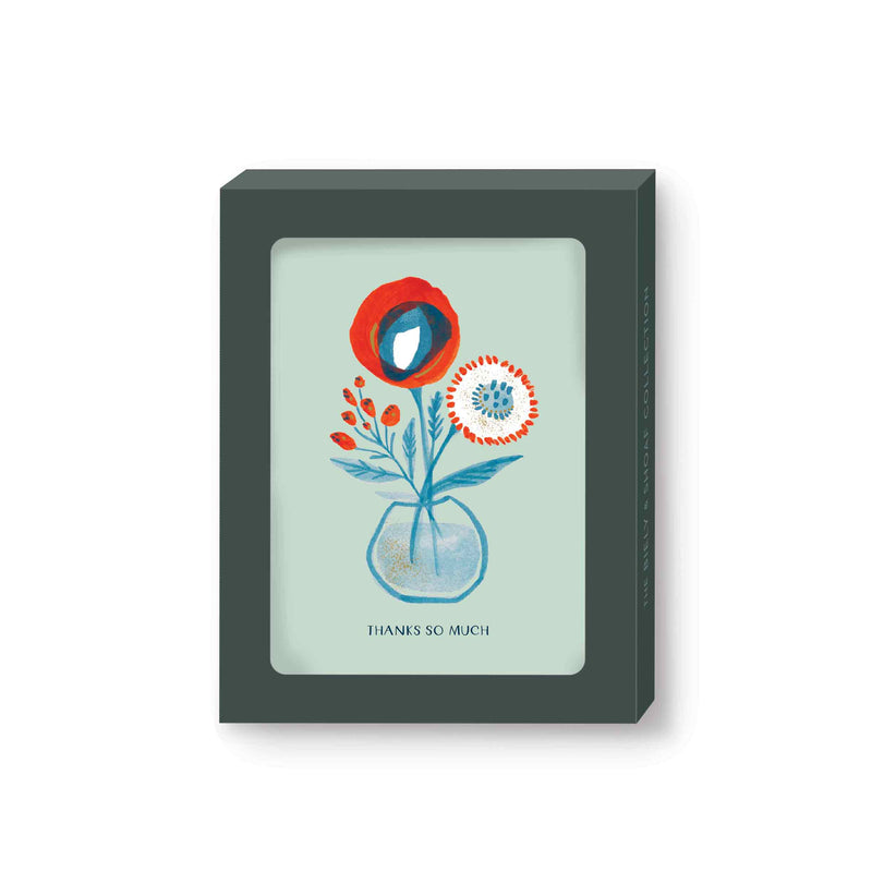 Boxed notecards featuring abstracted red and blue poppies, mums, and berries in a small clear vase. On a background of pale aqua blue