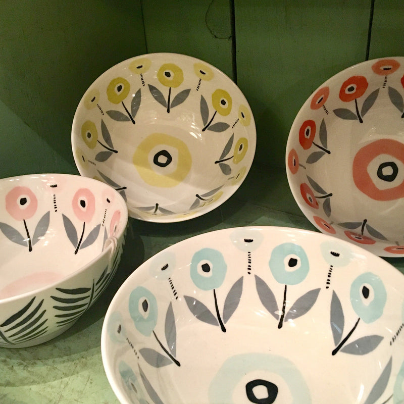 Mod Poppies Ceramic Bowls by Misha Zadeh for 180 Degrees. Shown in a shabby chic green cupboard