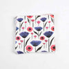 Red, Pink, Purple, and Indigo Poppies and Tulips dance about in this repeat print pattern by Misha Zadeh. Printed on a set of paper napkins and sitting on a plain white background